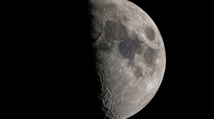A close-up of the Moon showing crater detail and shadows along the terminator