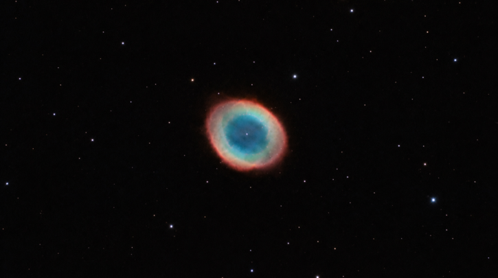 The glowing ring shape of the Ring Nebula against the night sky