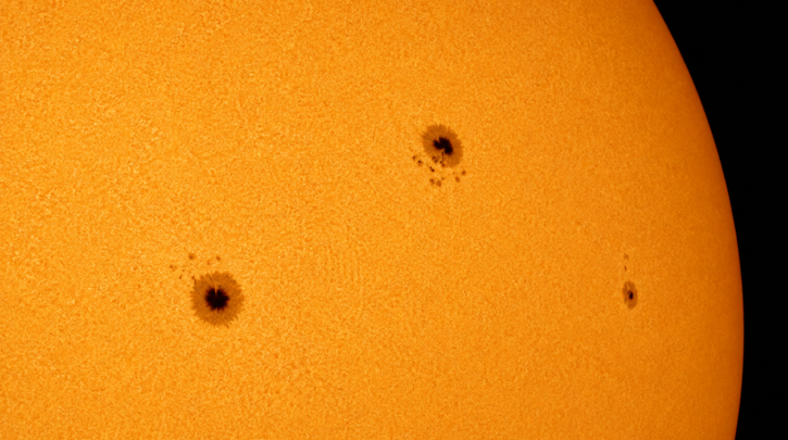 The Sun's surface showing dark sunspots against the bright photosphere